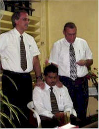 Rev. Hamid being ordained by Rev. Donnan and Rev. Poettcker
